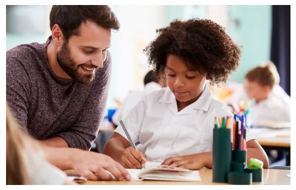 teacher giving assistance to student
